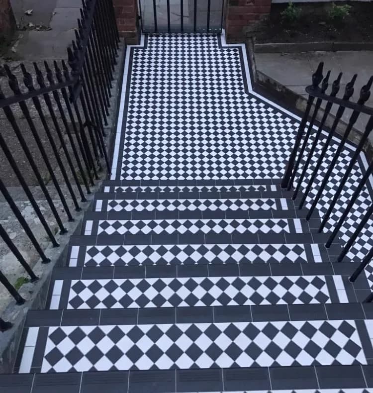 Black and white checkerboard Victorian tiled front path and steps with original iron railings